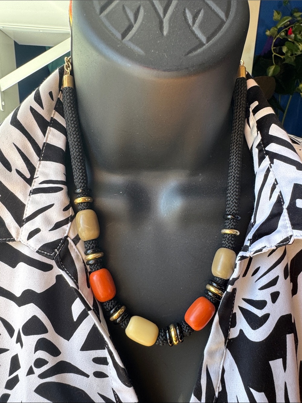 Earth toned, chunky plastic bead necklace on black cord